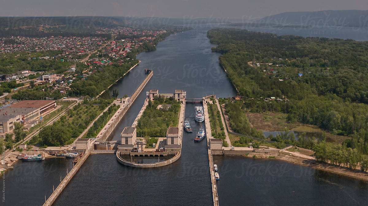 Top-view of a barge ship passing by the gateway