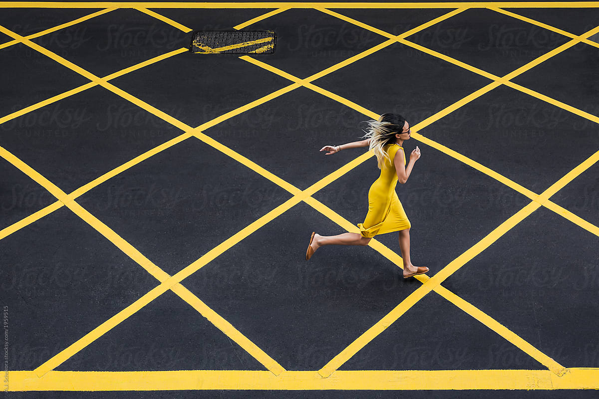 Woman in yellow dress running