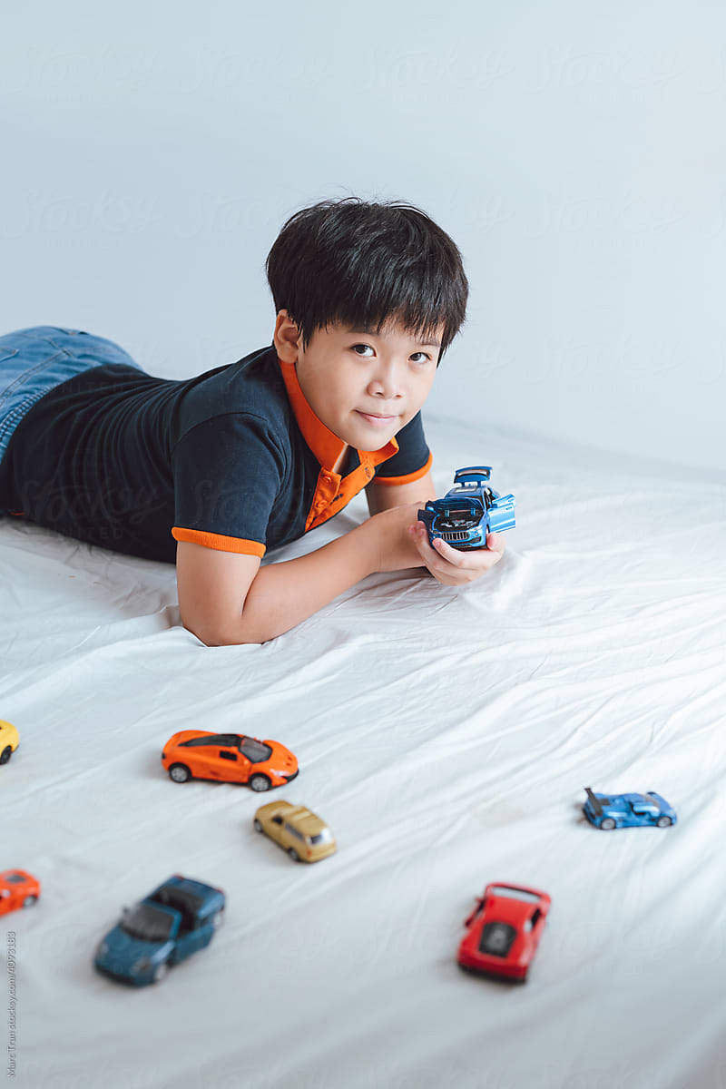 Children playing with cars toys on floor