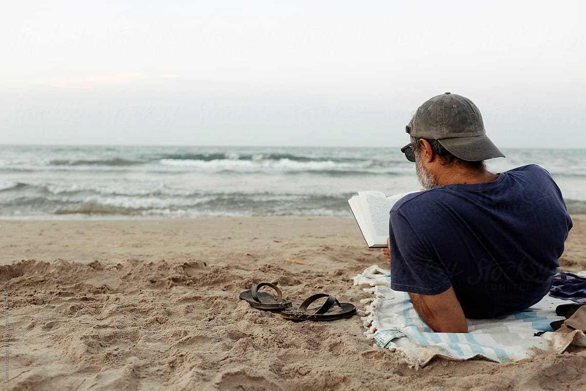 Man reading at the beach