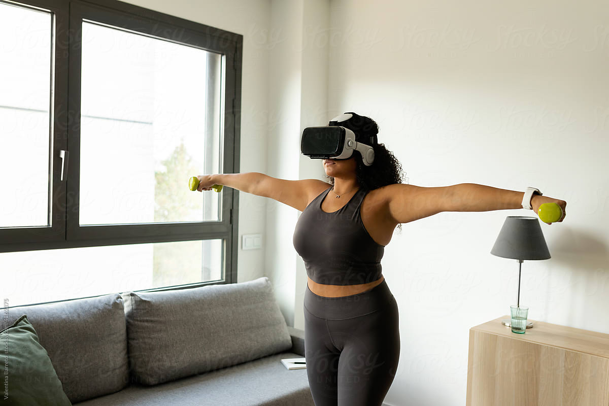 Woman exercising at home with virtual reality