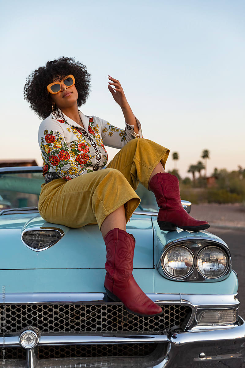 Confident African American Woman next to Vintage American car