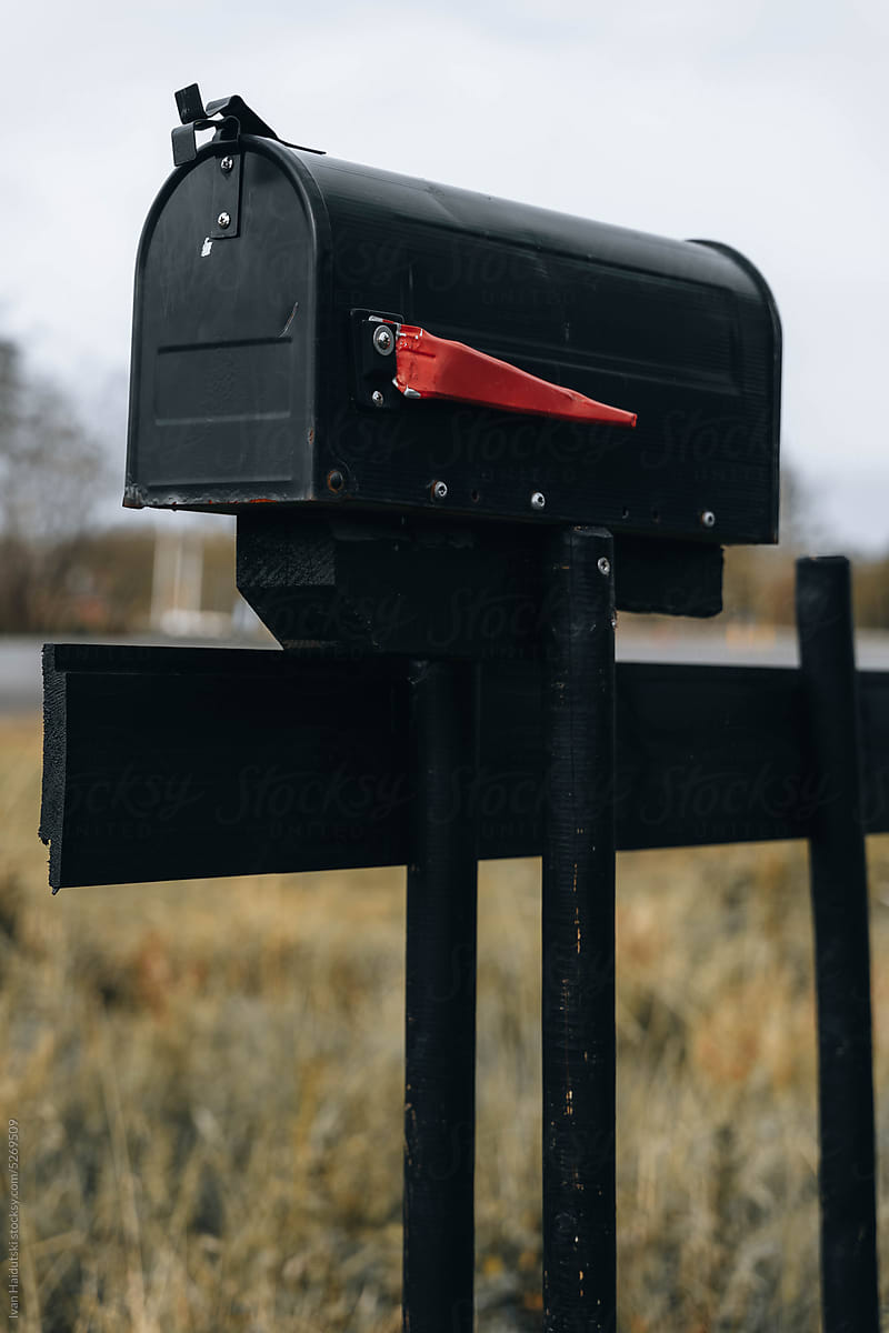 Black Rural Mailbox. The red lowered flag to show mail is not in.