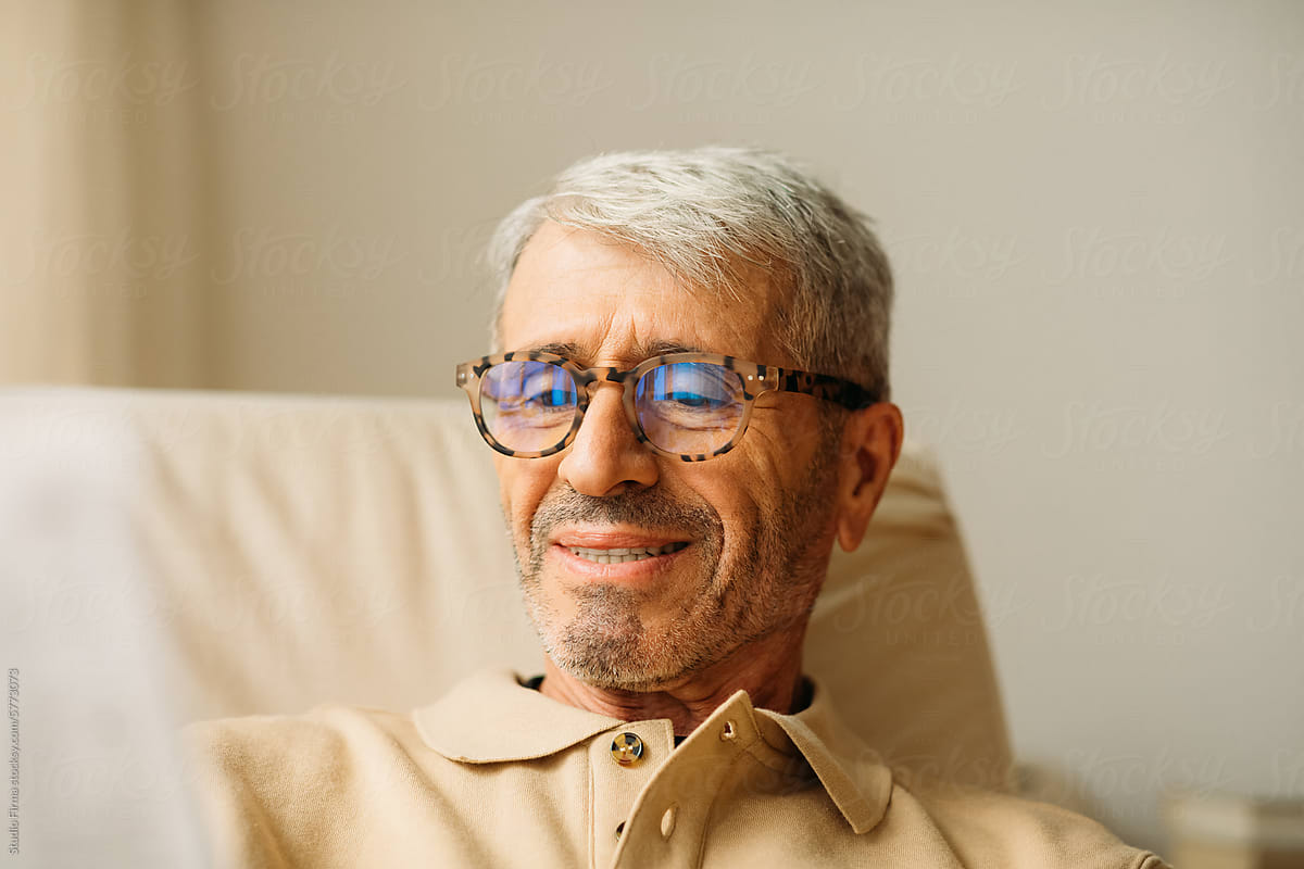 Senior man reading at his home