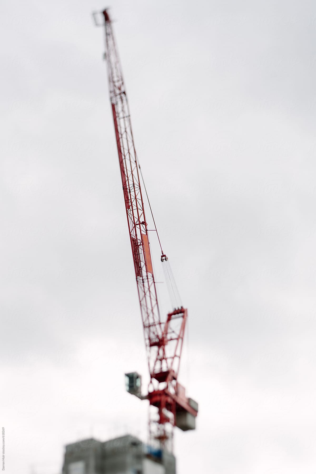 Construction crane on top of a high-rise building.