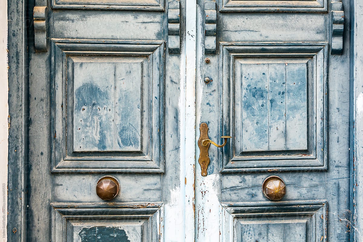 Symmetrical Detail of a Weathered Traditional Blue Door