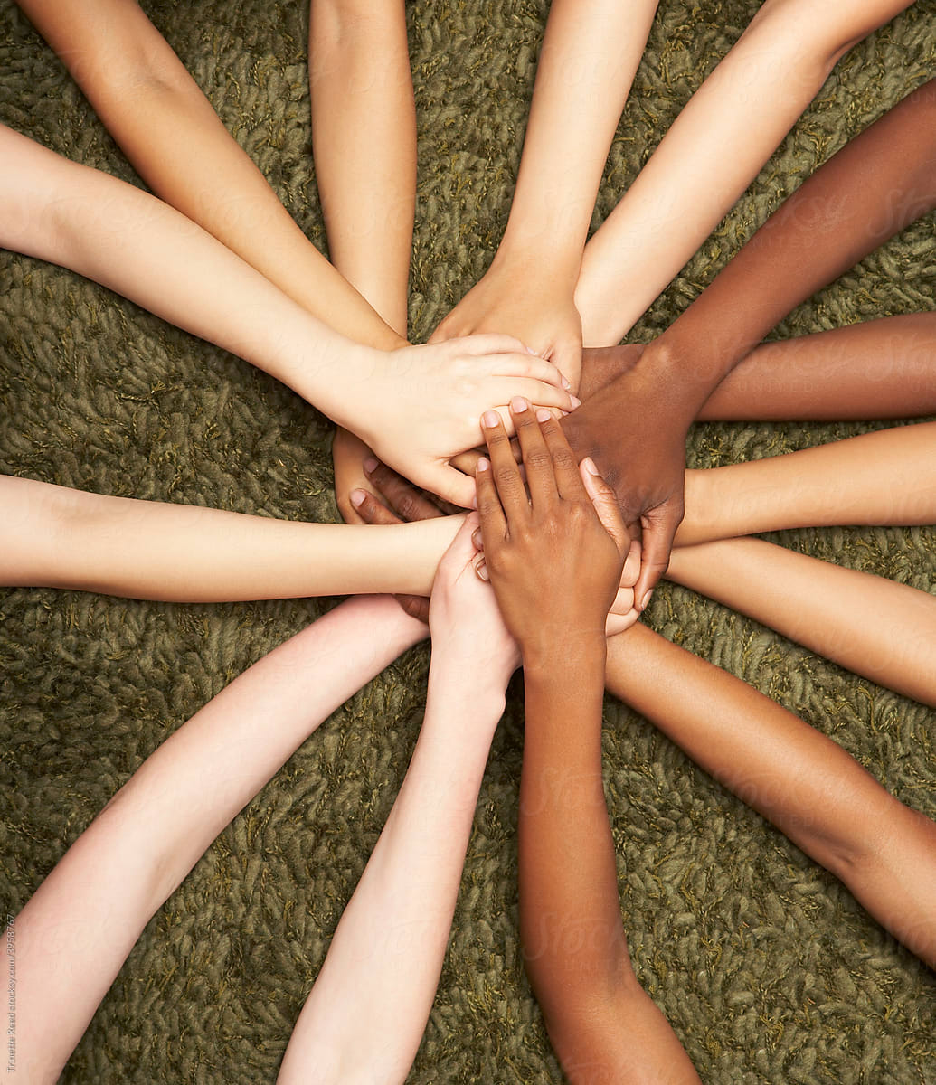 Group of diverse women\'s hands connected together in unity