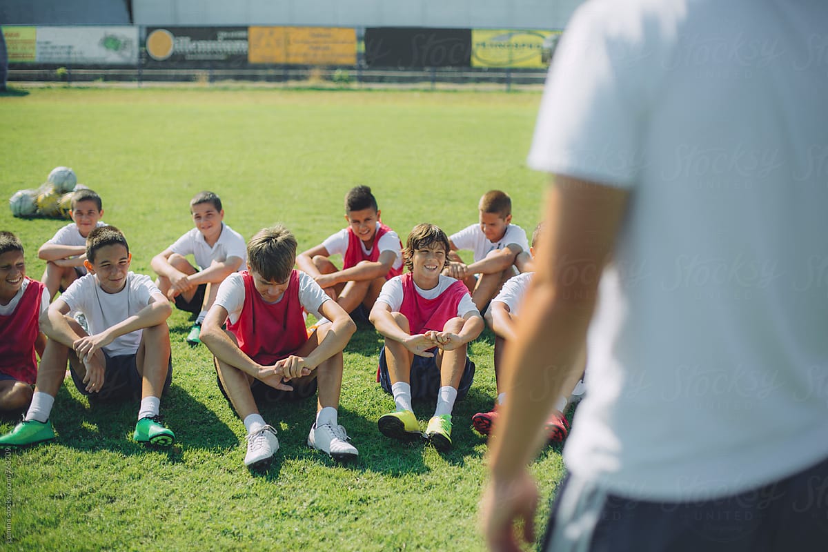 Boys Listening to Their Football Coaches