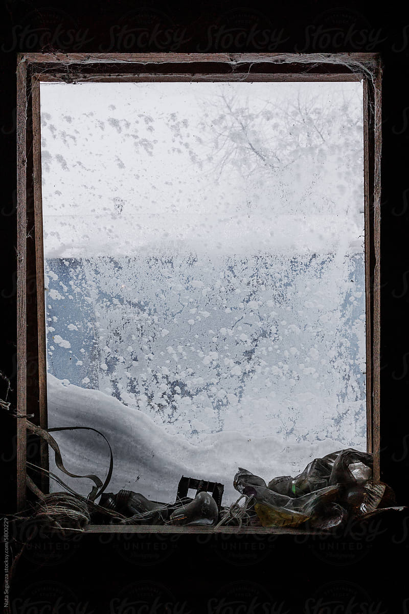 Snowy window with frosted patterns