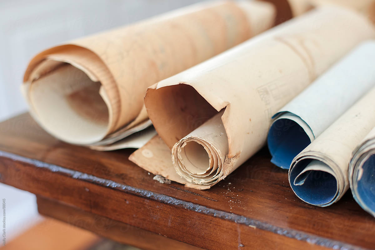 Close up of rolled documents on a wooden desk