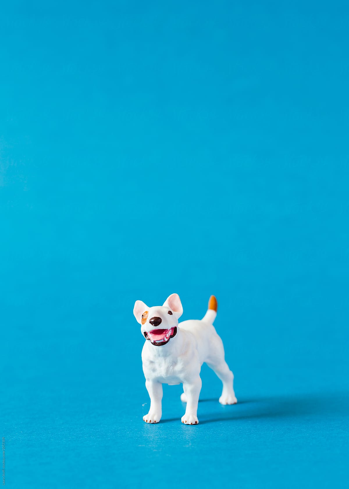 Amstaff dog shaped miniature on blue