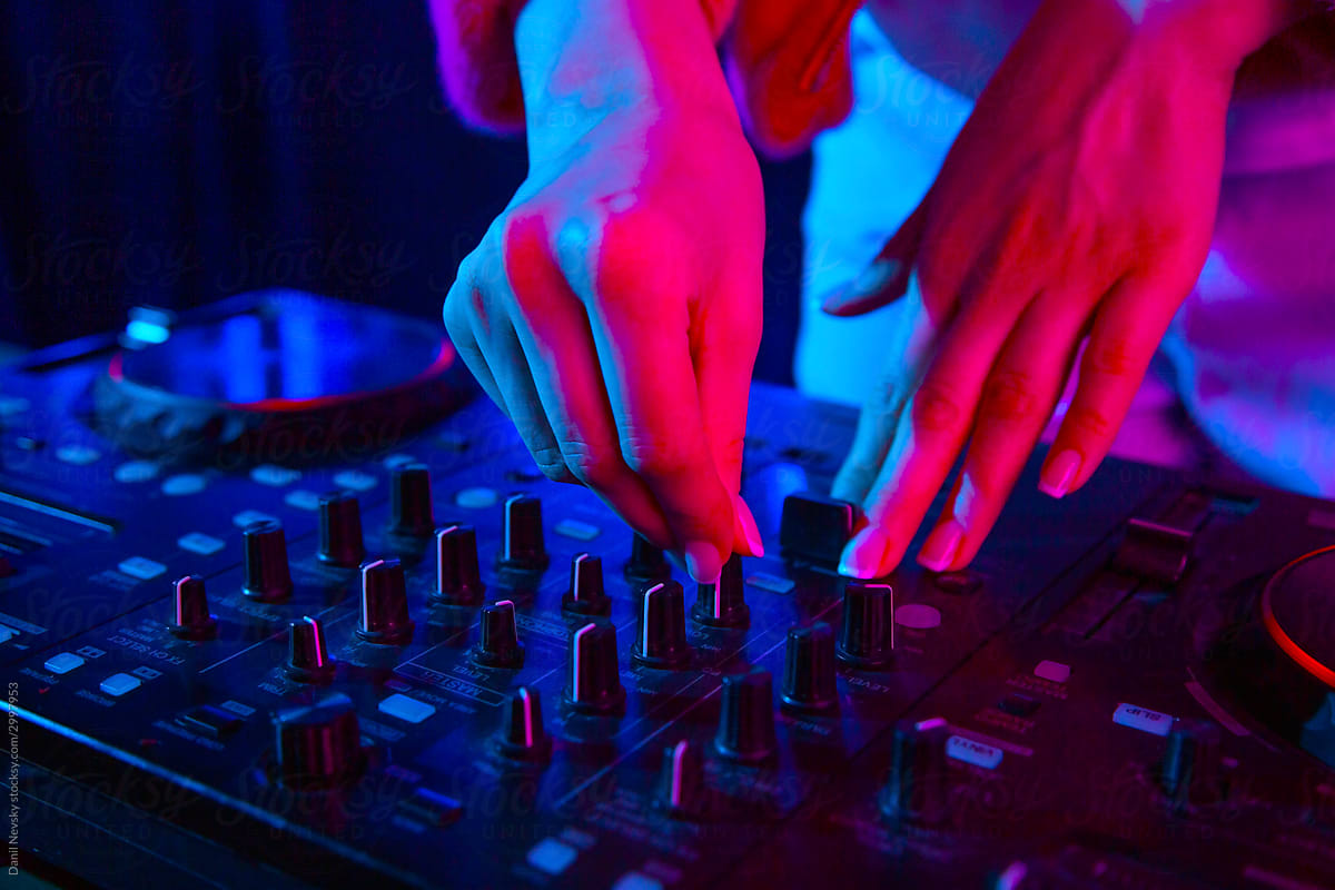 DJ controlling music in night club