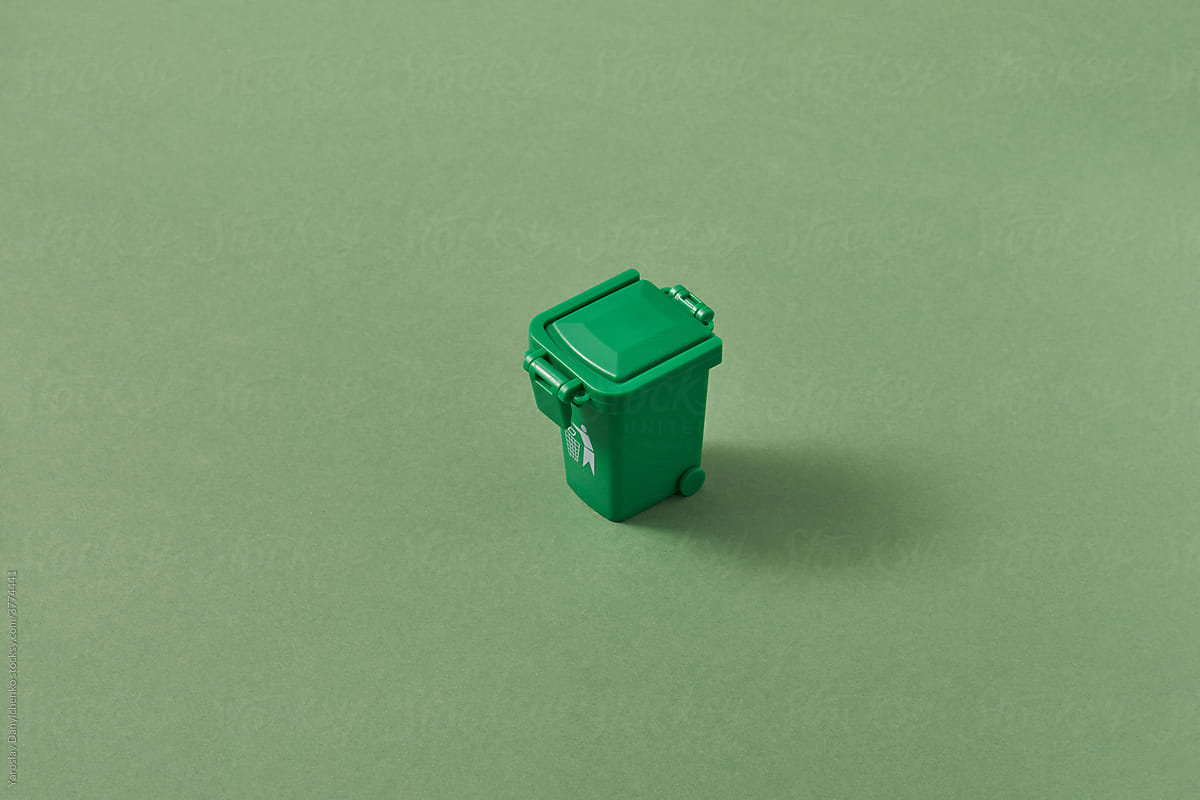 Small closed green trash can