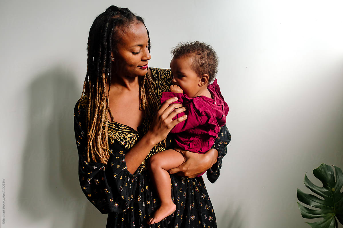 Beautiful black mom holding biracial daughter