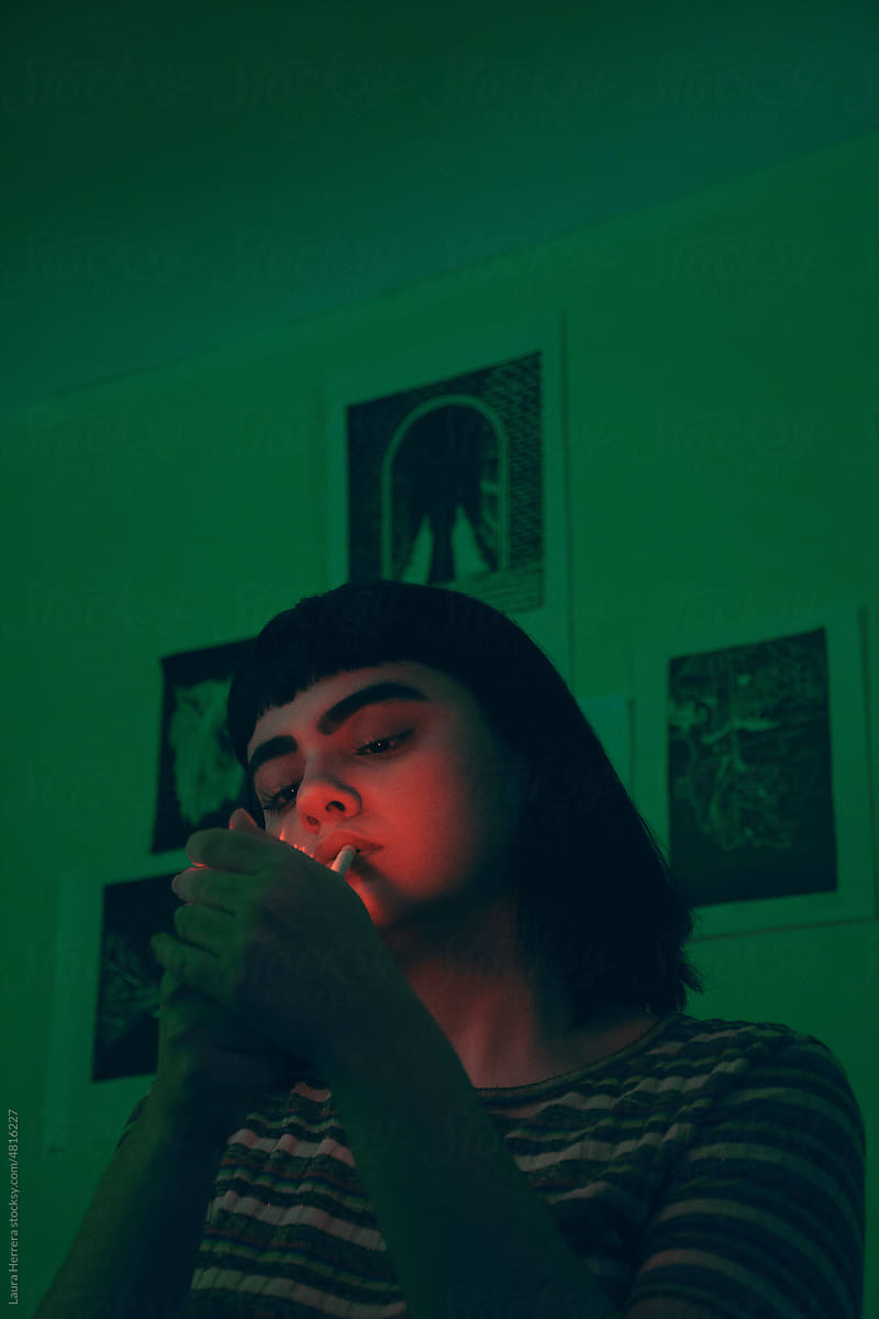 Mysterious Model with Green Lighting lighting a cigarrette