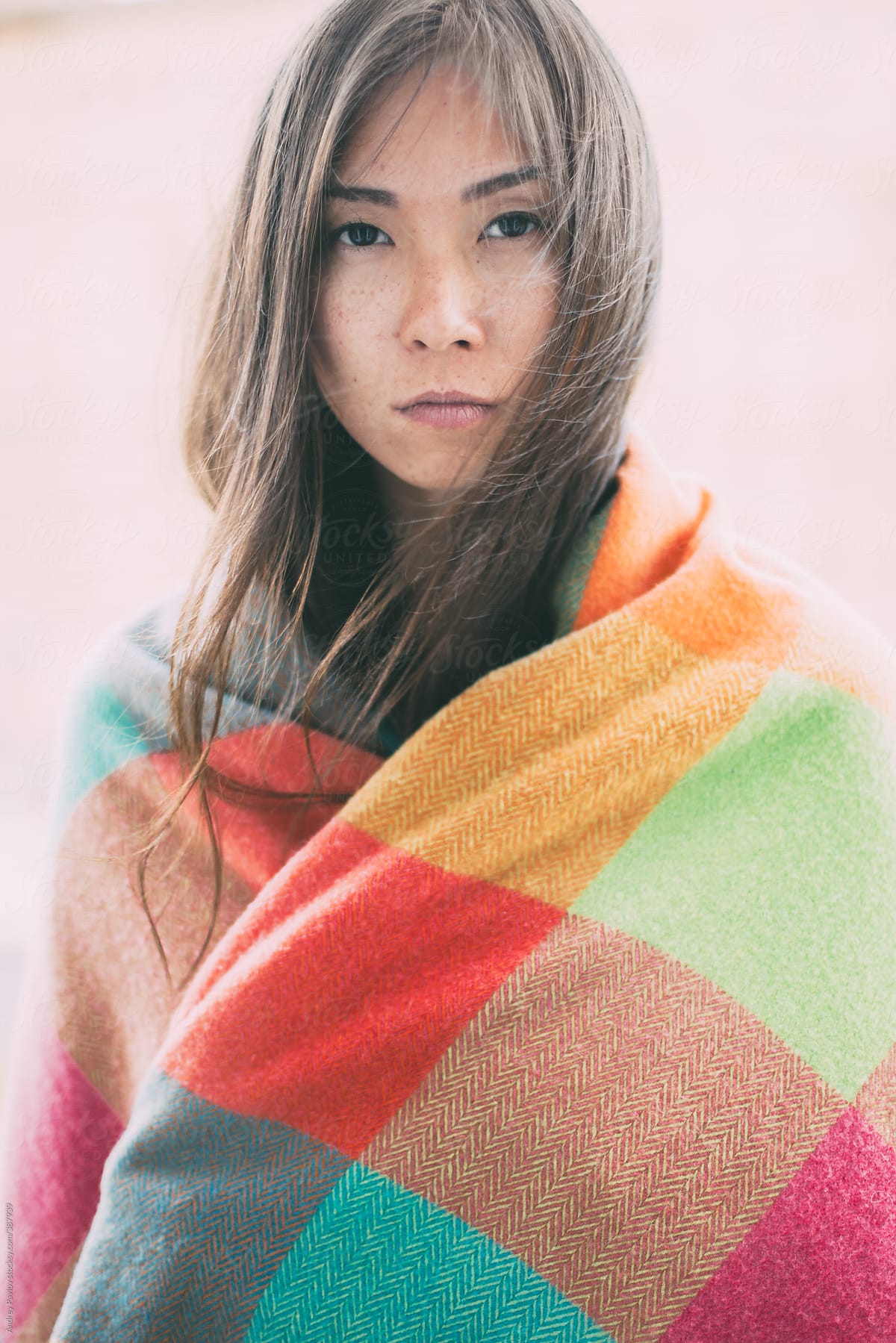 Beautiful Woman Wrapped In Colored Blanket Looking At Camera By Stocksy Contributor Andrey