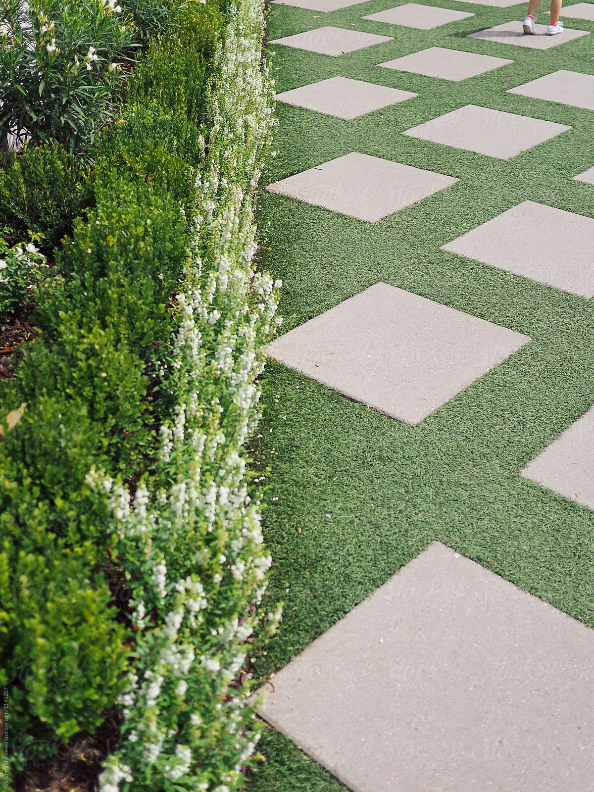 Concrete tiles and fake grass used in landscaping