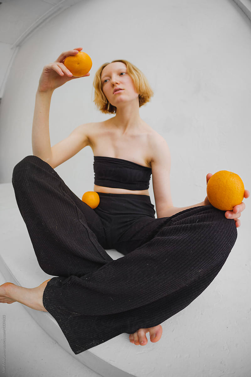Woman Examining Orange Fruit Composition