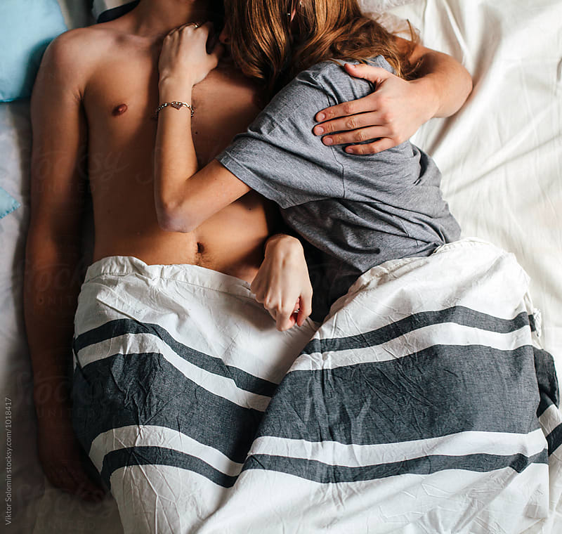 Young couple in love lying in bed