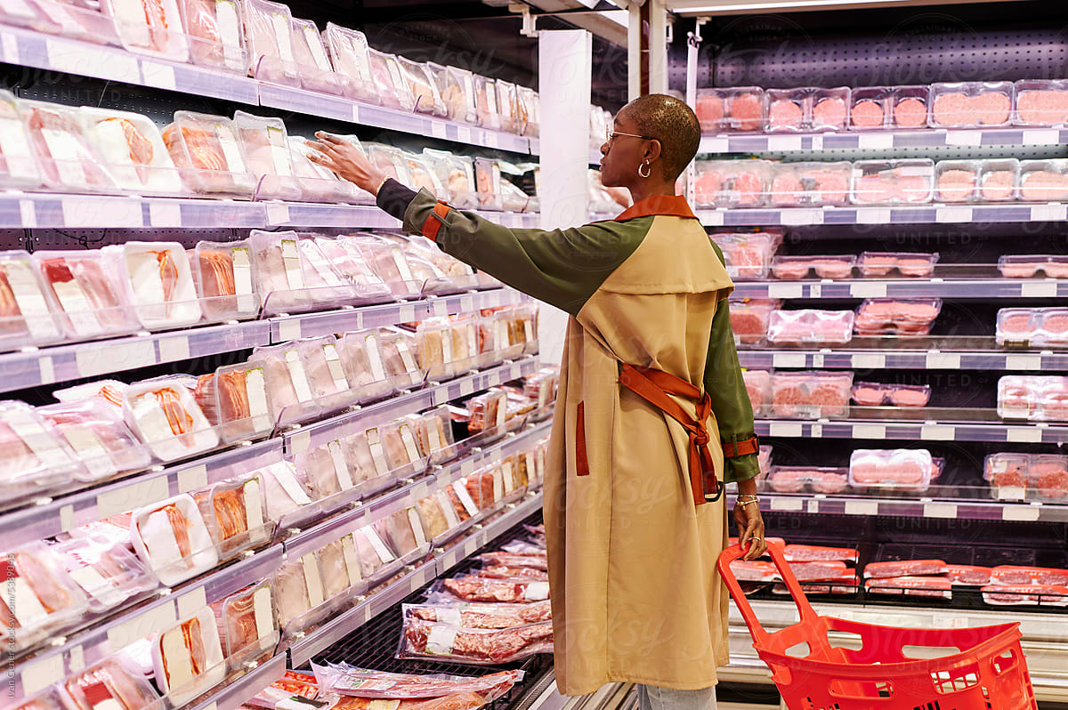 Woman shopping for meat in a supermarket