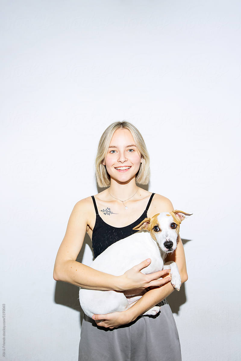 Smiling Woman Holding A White Dog
