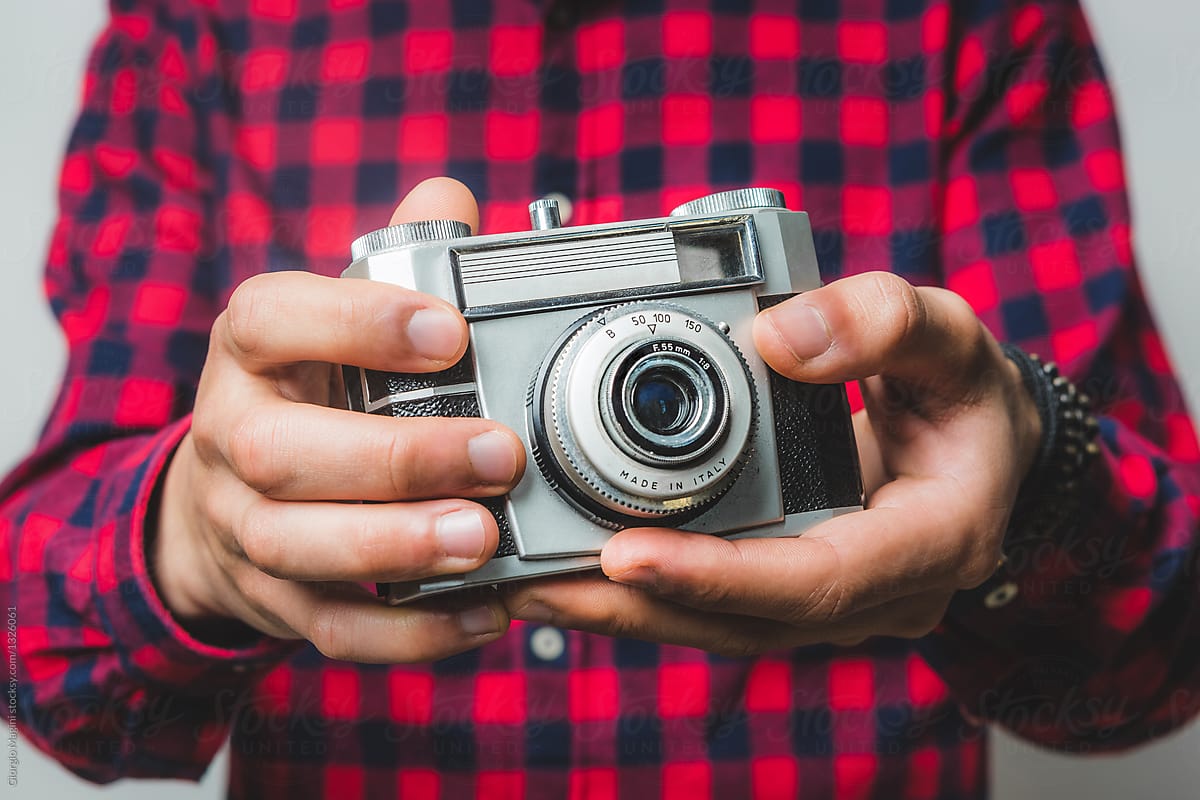 Young Creative Man Holding an Old Film Camera