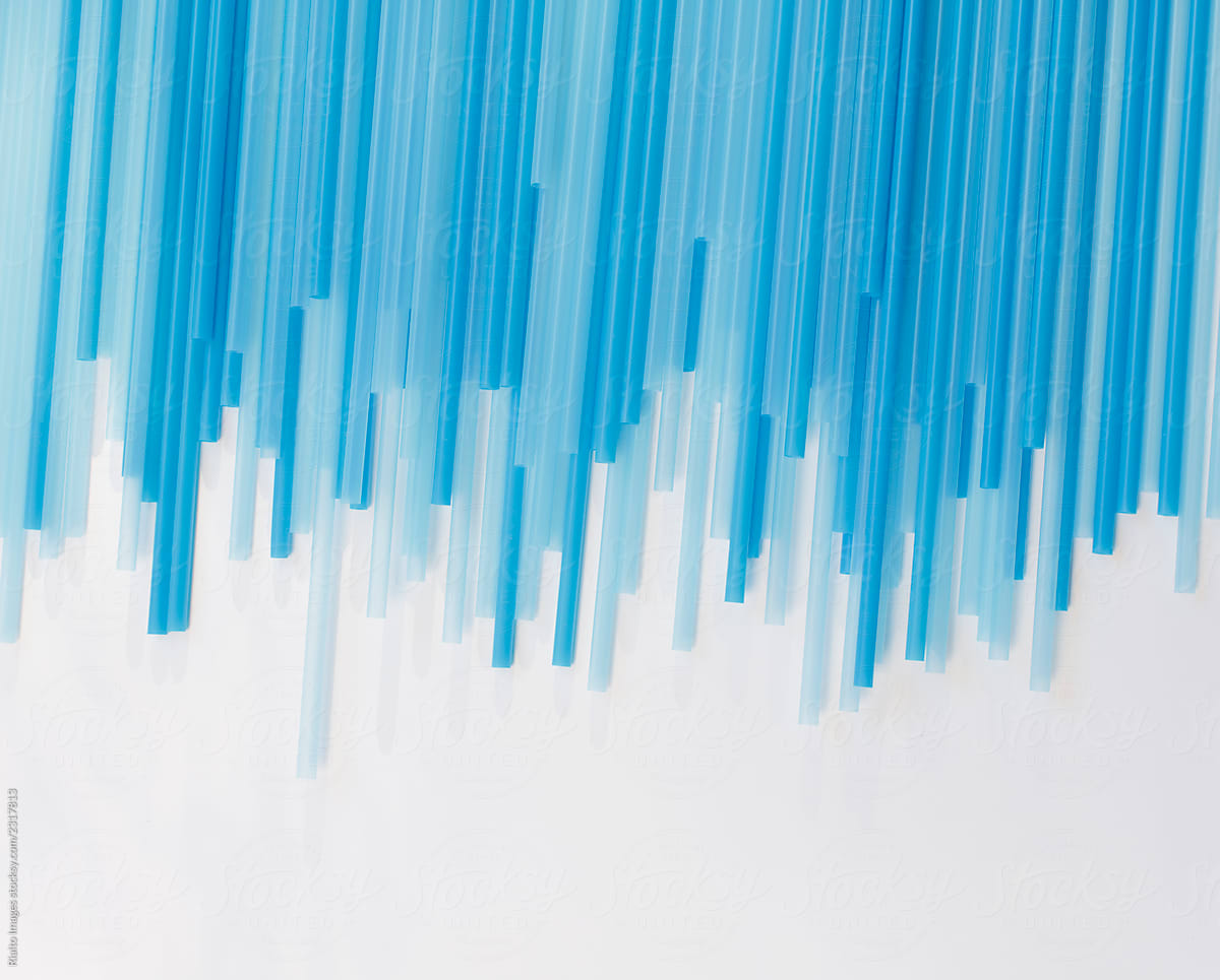 Plastic blue drinking straws on white background