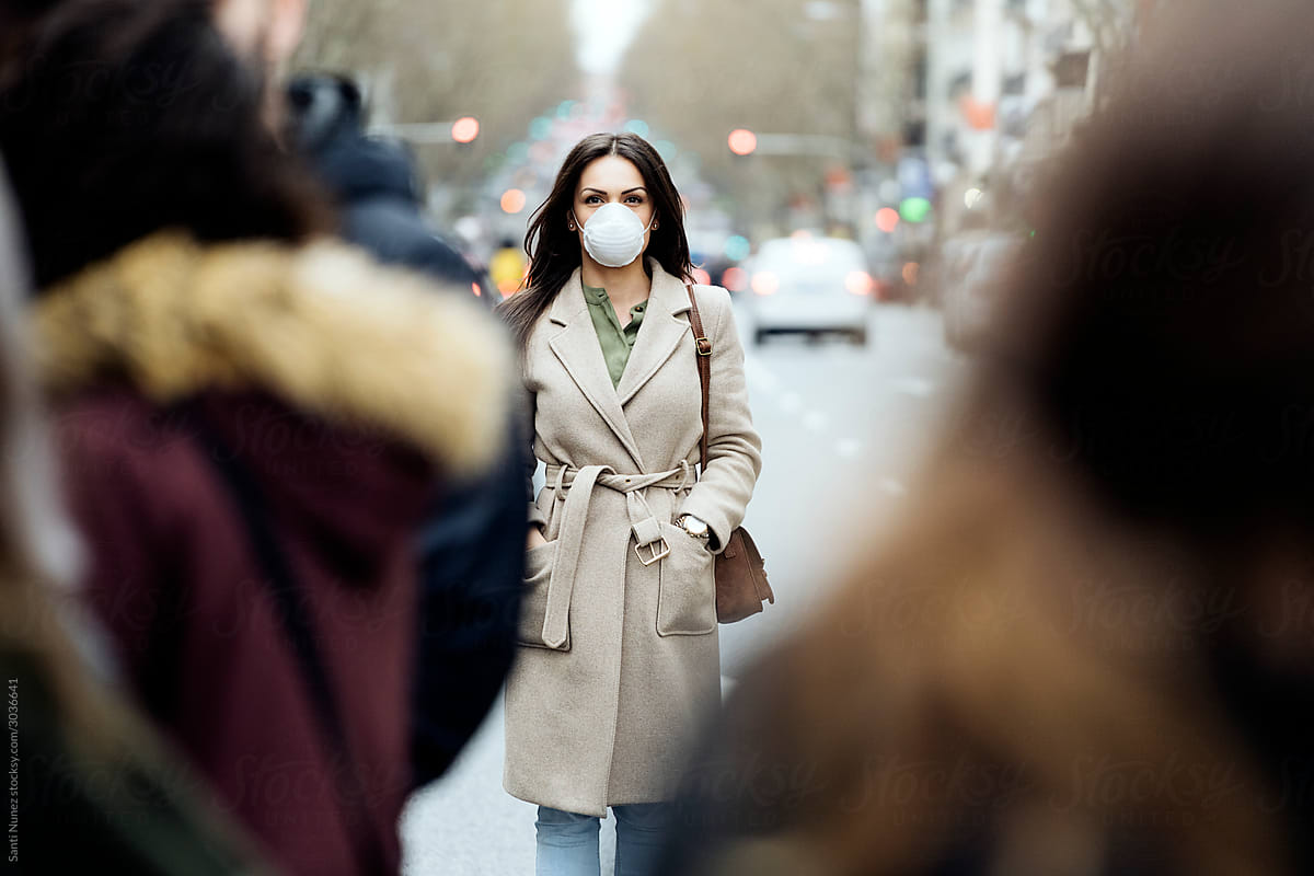 Woman covering her face with protective mask