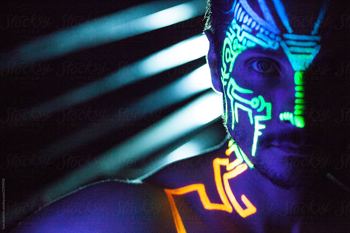 Young Man With Neon Painting On His Face by Stocksy Contributor