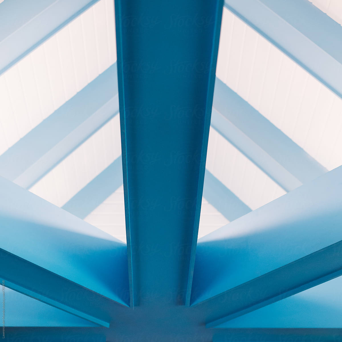 Detail of and closer view of the light on the light blue beams supporting the roof  of a restaurant