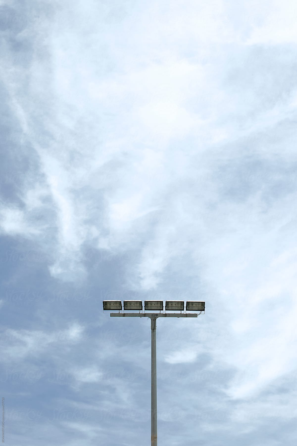 Stadium light over cloudy sky.
