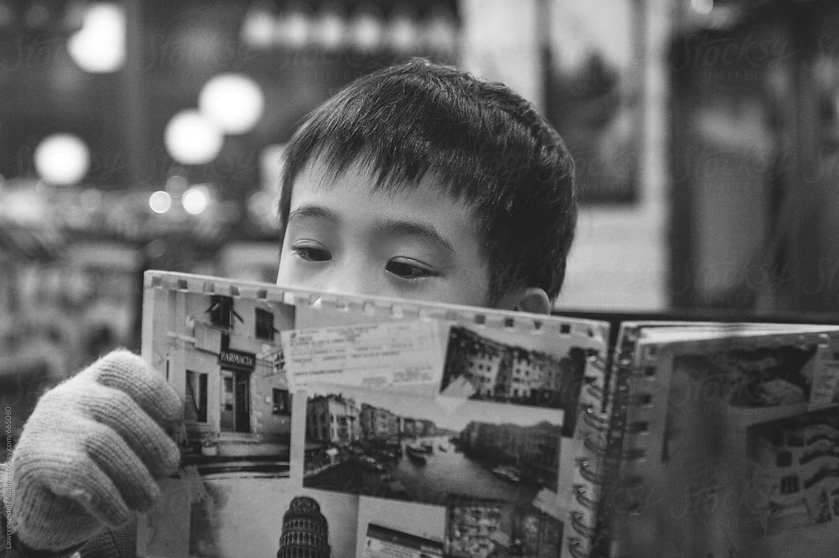 Boy reading the food menu in a restaurant
