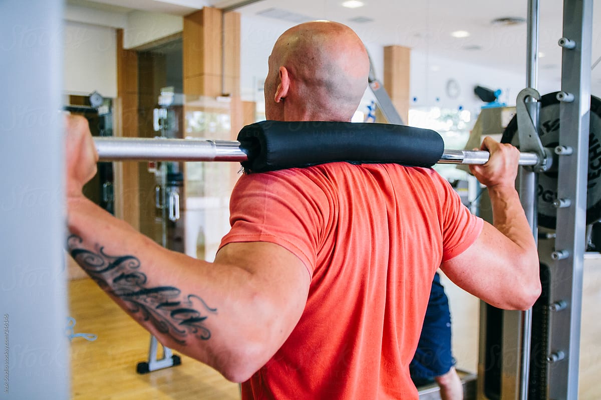 Man training with gym machine in a gym
