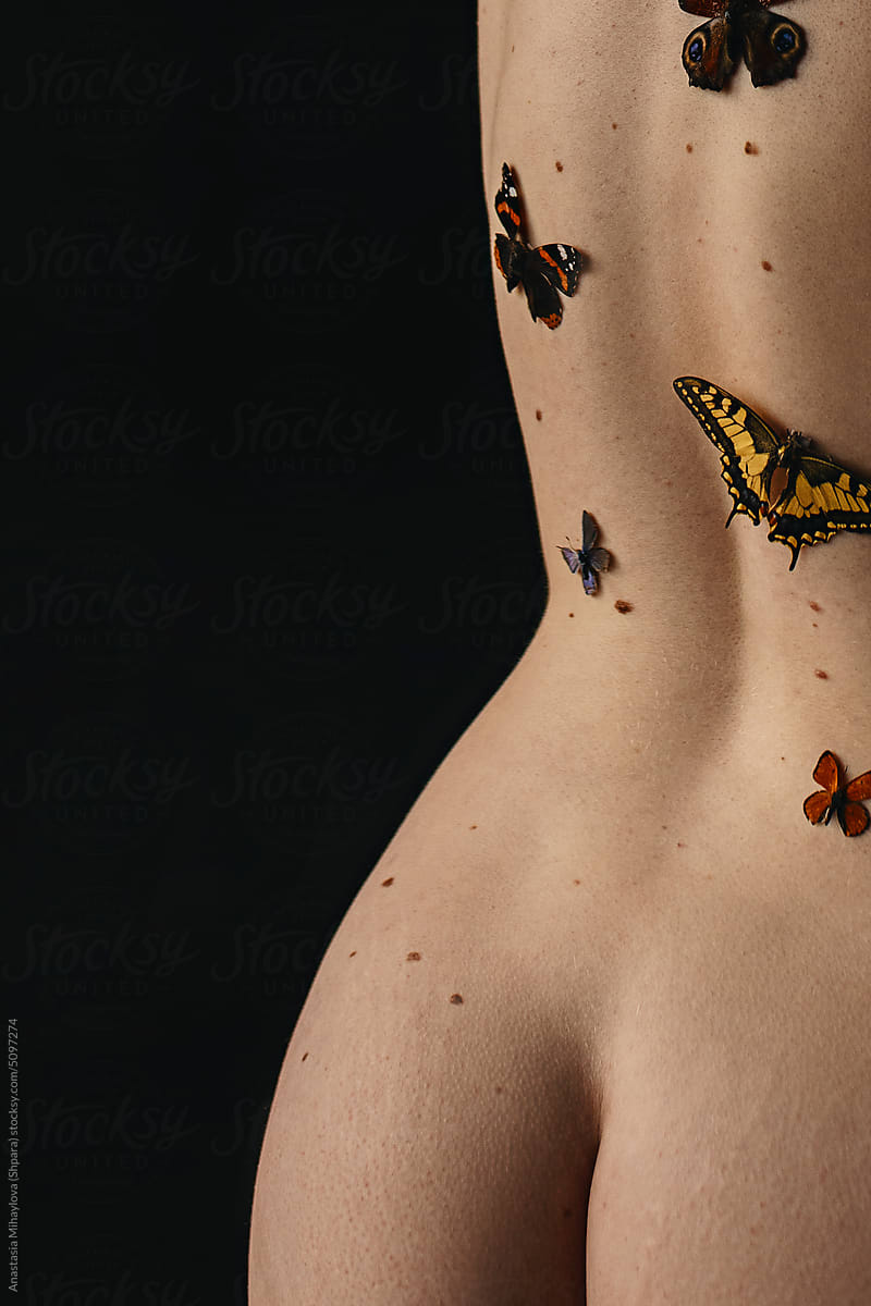 Close up photo woman's buttocks skin texture with moles and butterfly