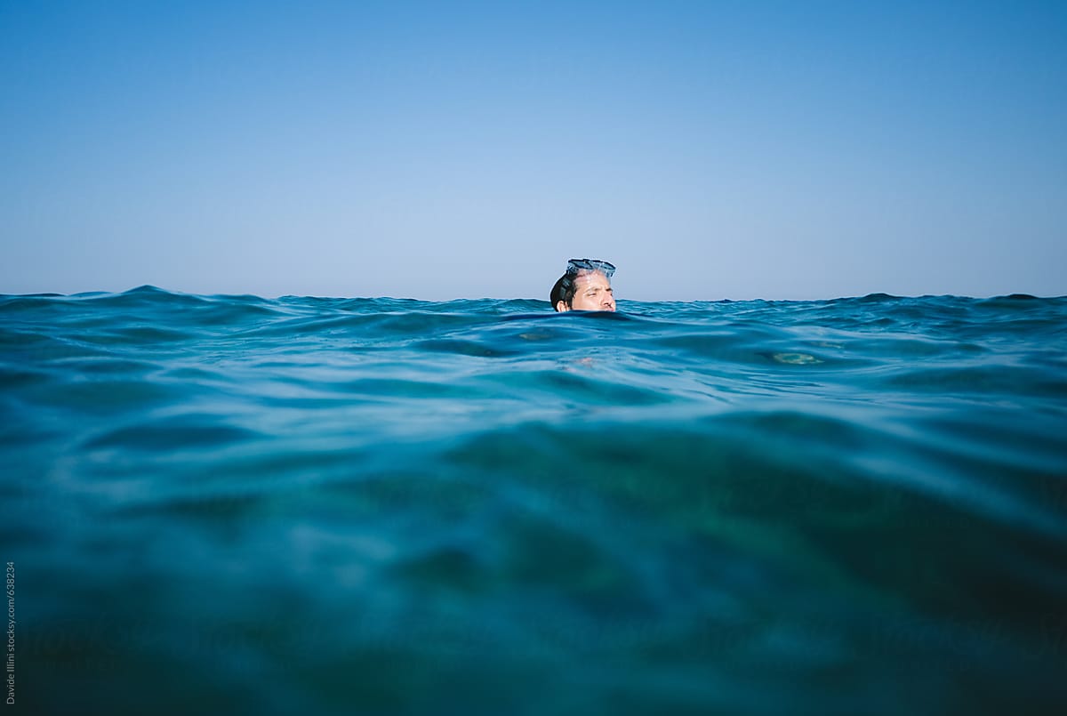 Young man swims in the sea