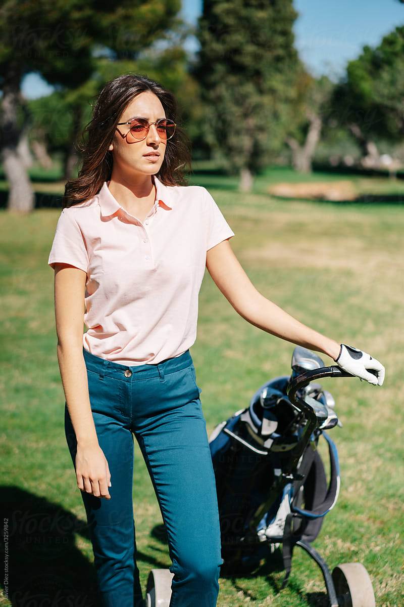 Female golf player with bag on course
