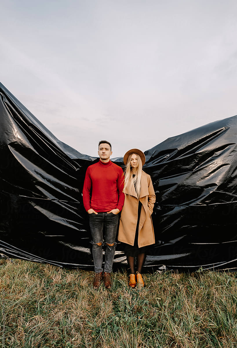 fashion outdoor portrait of young people on black plastic background