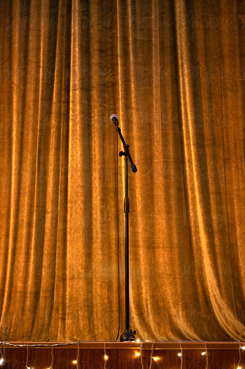 Microphone on stage with curtains behind