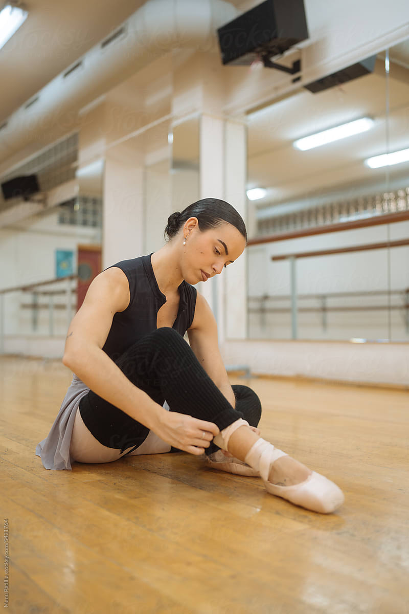 Young female dancer wearing black leggings in ballet studio