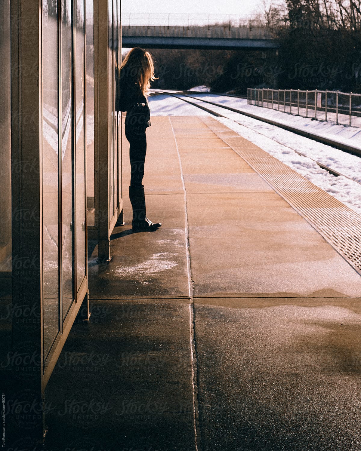 solitary woman waits for a train