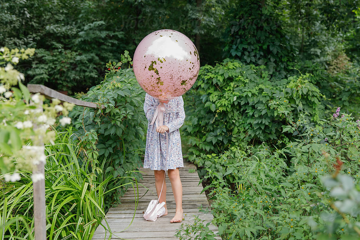 A birthday girl with a pink balloon