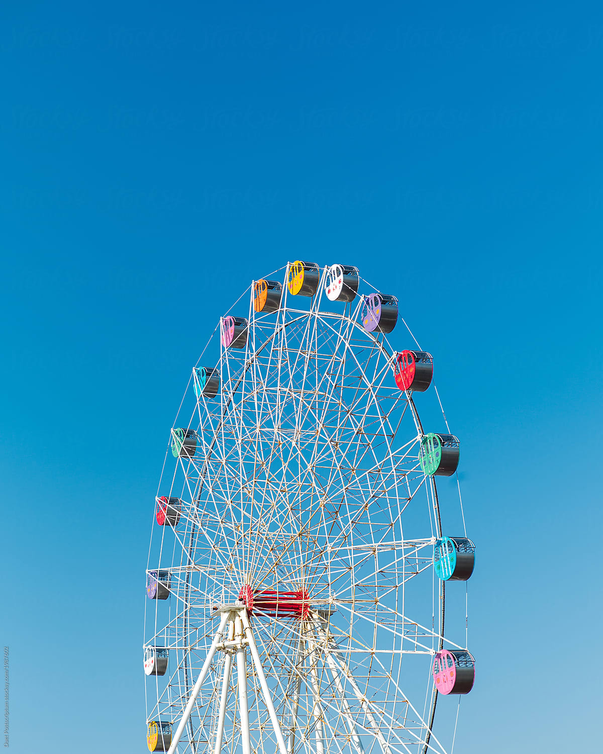 Colorful Ferris wheel on blue sky