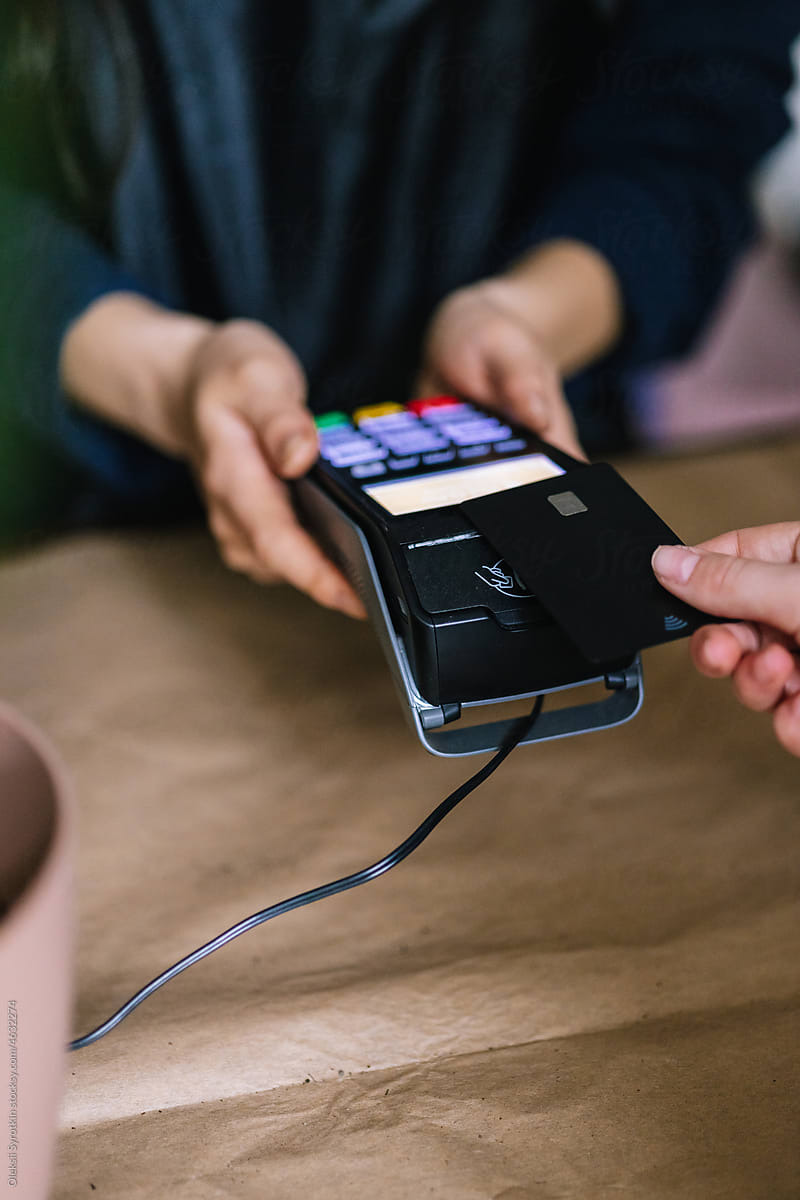 Customer applying cedit card to contactless terminal