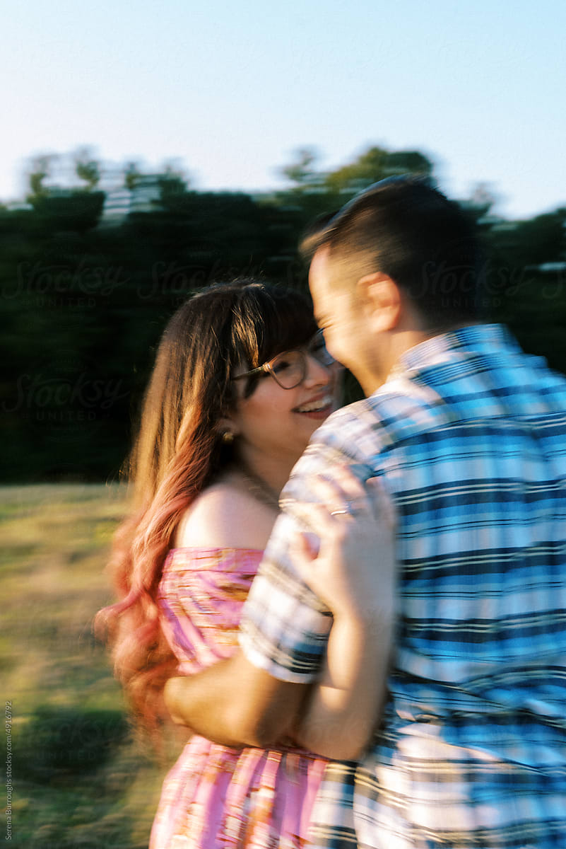 blurry lo-fi Portrait of Smiling Expectant Couple