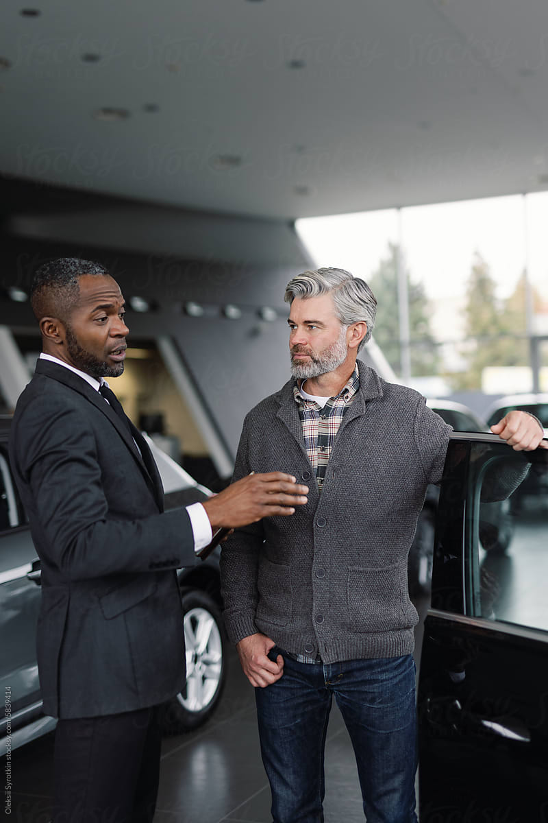 Sales representative  customer discuss modern car options