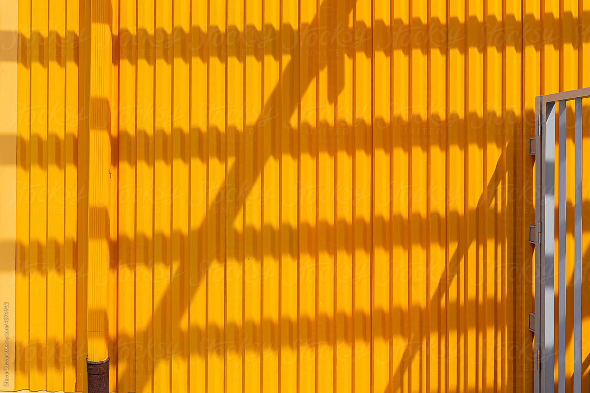 Yellow metal wall with shadows