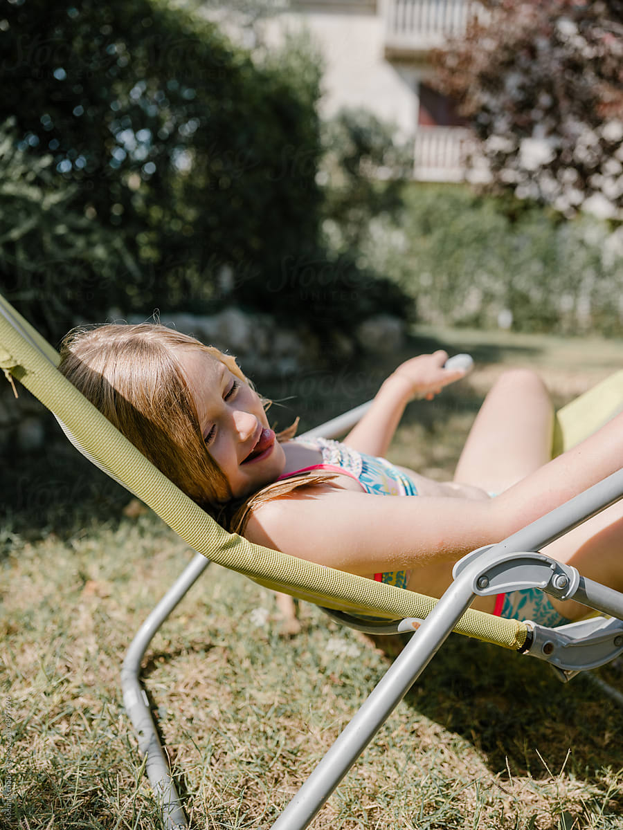 Girl Relaxing on a Garden Sun Lounger