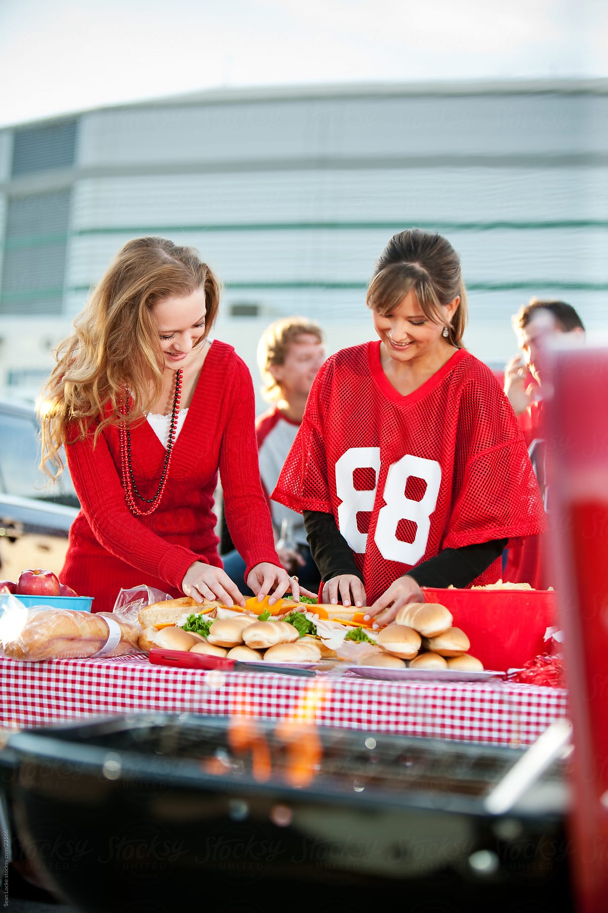 Tailgating: Women Help to Set Up Food for Party