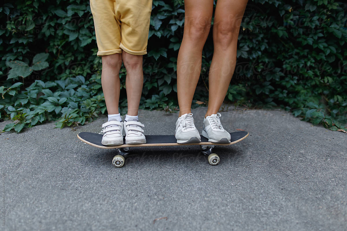 Woman and boy on a skateboard