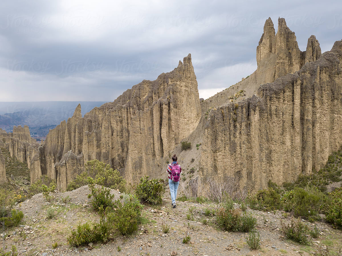 A woman standing alone on a hill in Valle de las Animas, La Paz, Bolivia